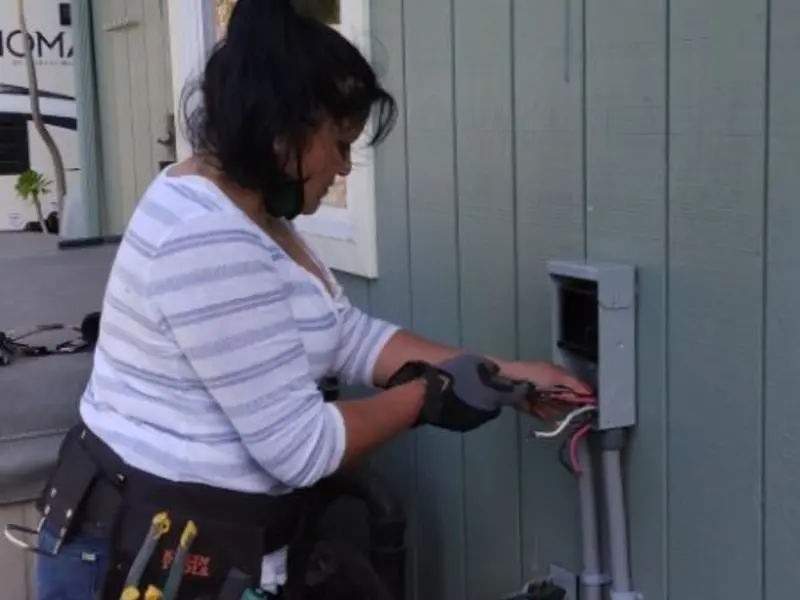 Licensed electrician wiring an exterior subpanel in Weatherford